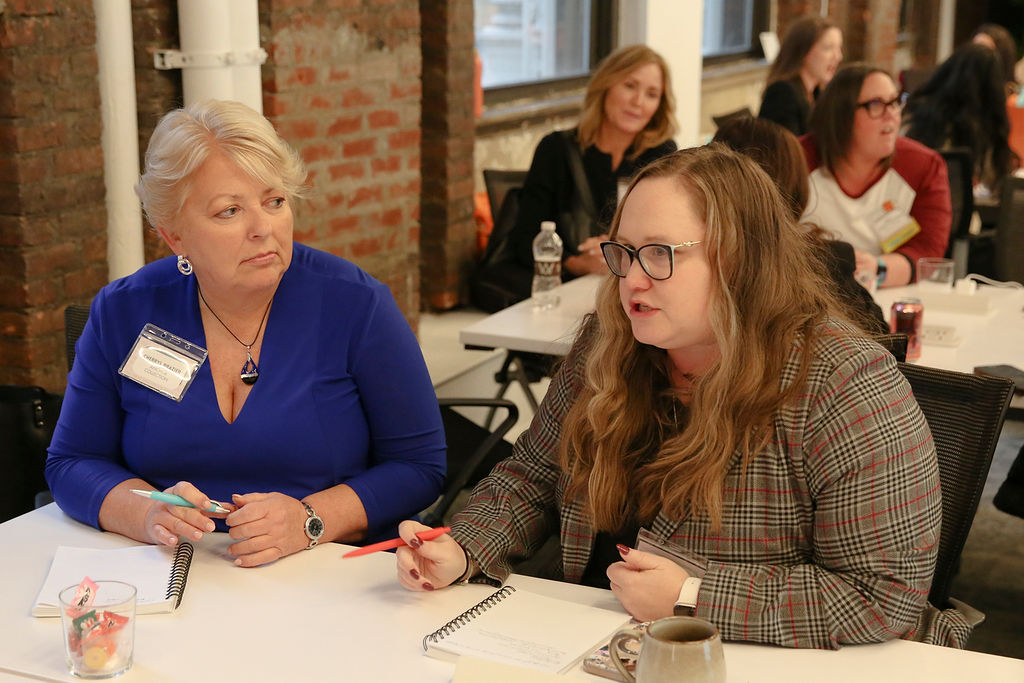 Two members in conversation at a workshop table